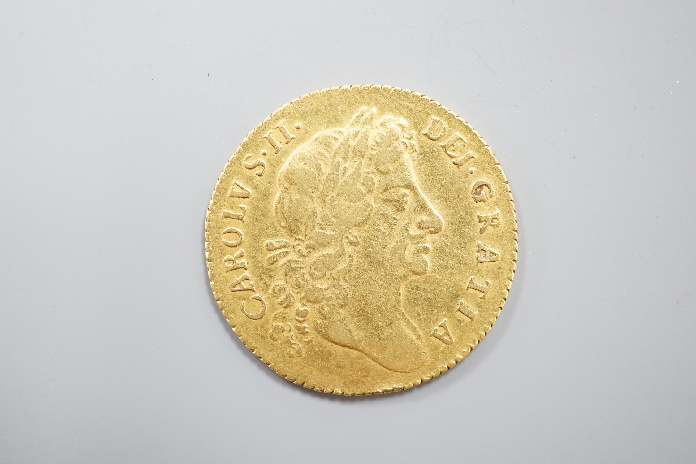 A Charles II gold guinea, 1676, F/VF.